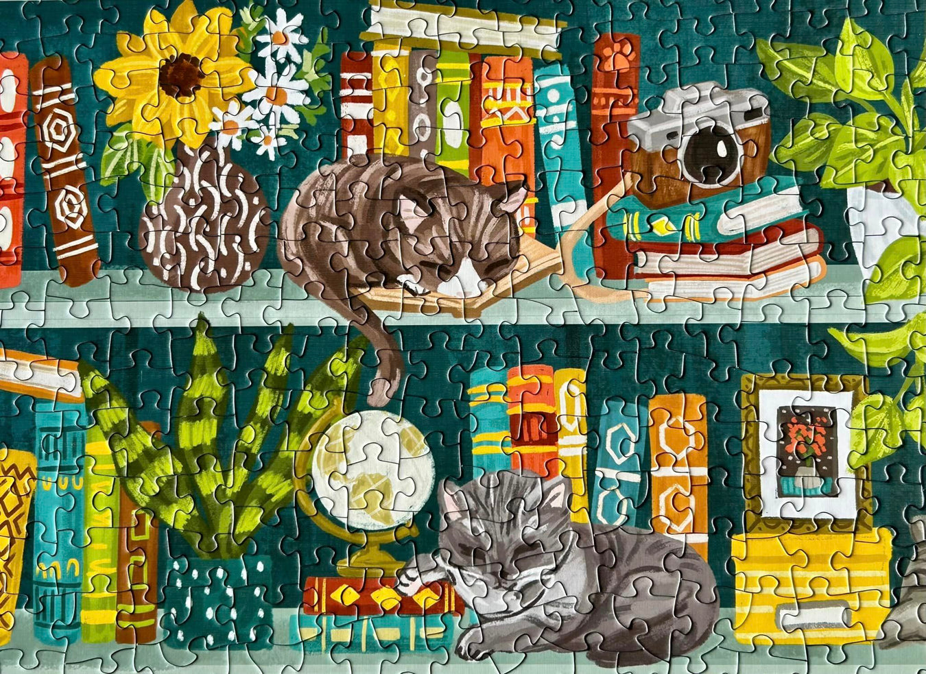 Cats on a bookshelf with books and plants jigsaw puzzle